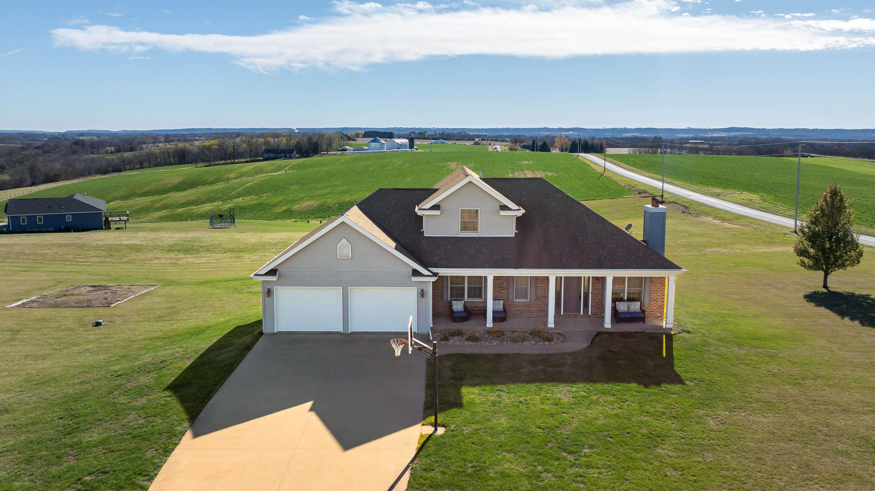 a aerial view of a house with a garden and lake view