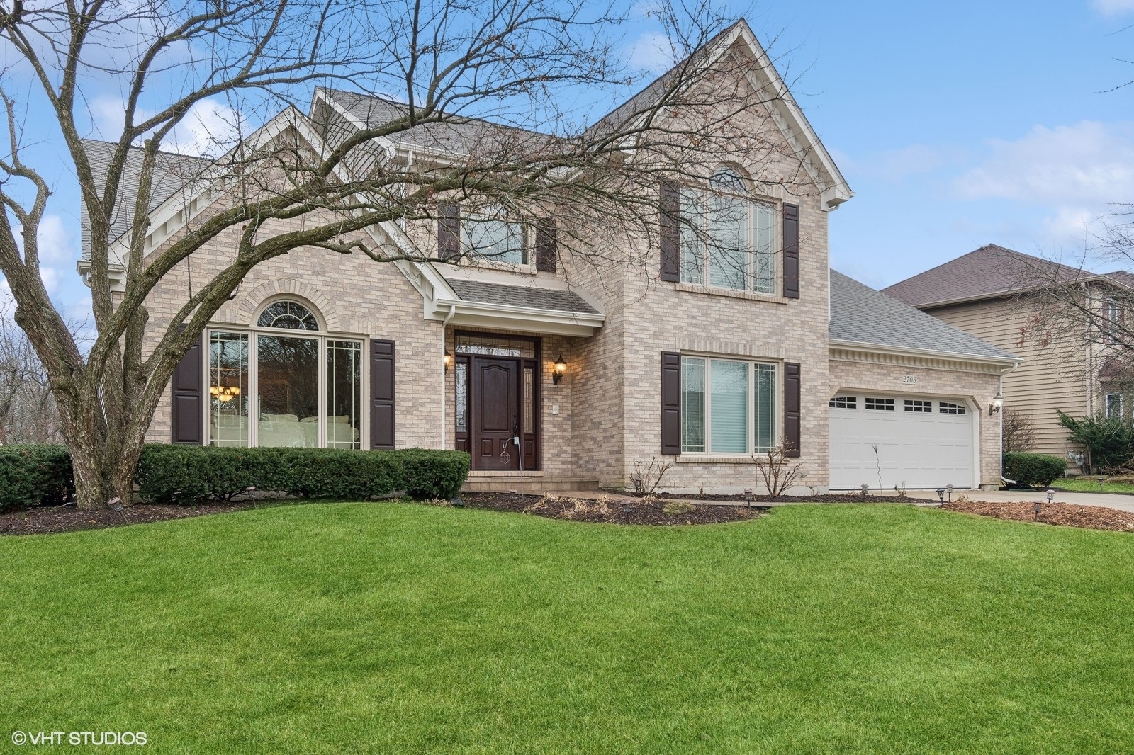 a front view of a house with a yard