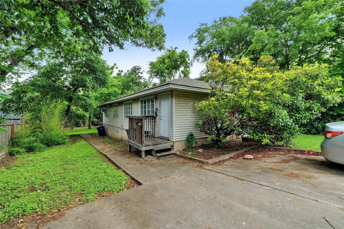 a view of backyard with a table and chairs under an umbrella