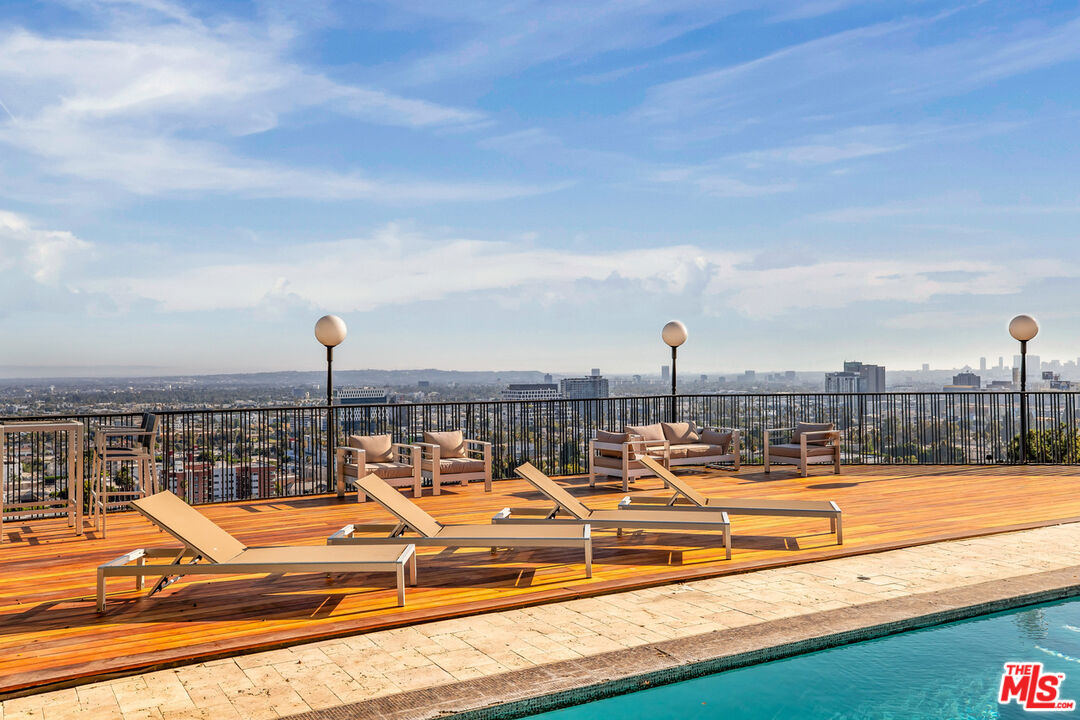 a view of swimming pool with outdoor seating