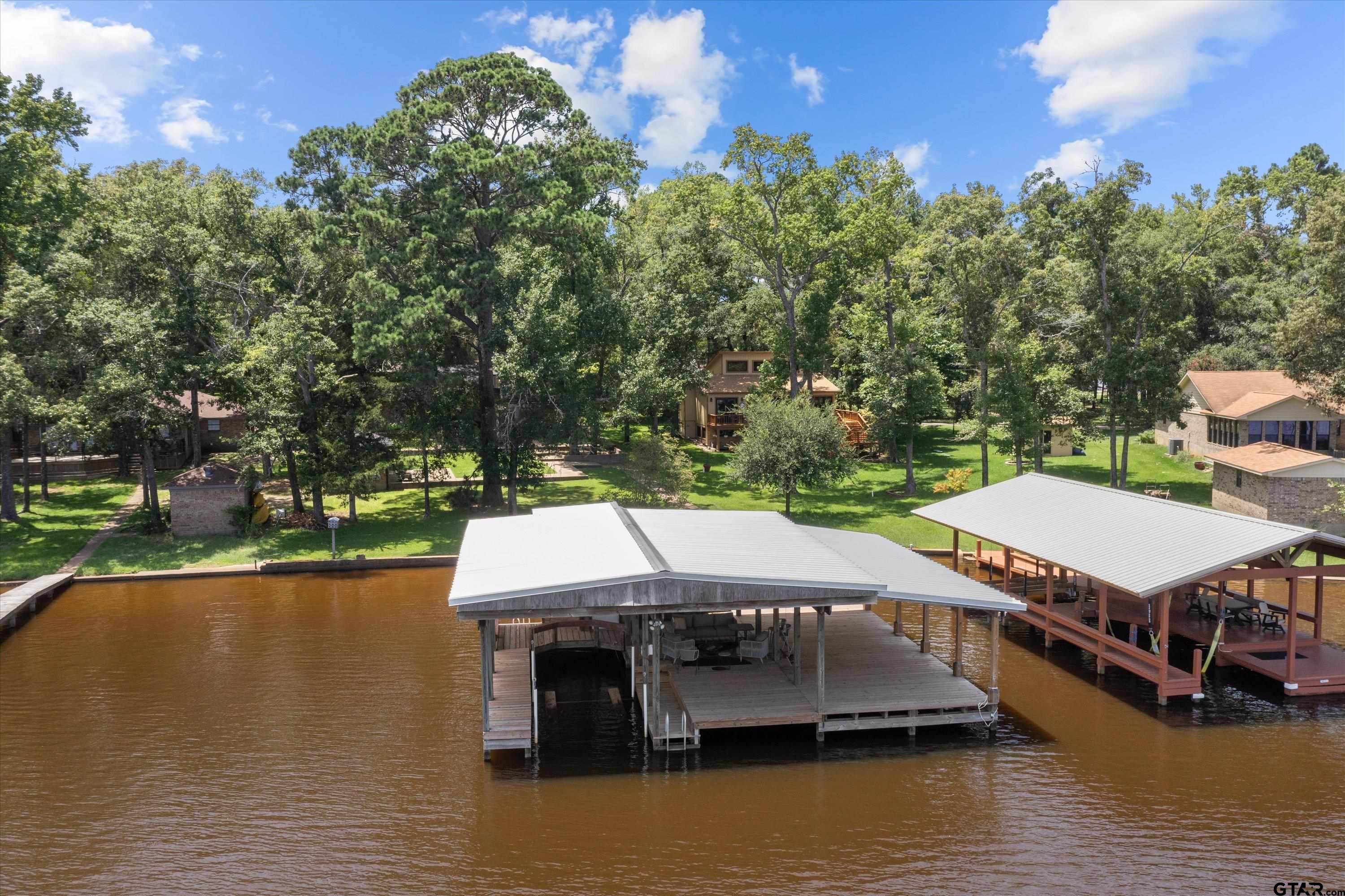 a aerial view of a house with swimming pool and lake view