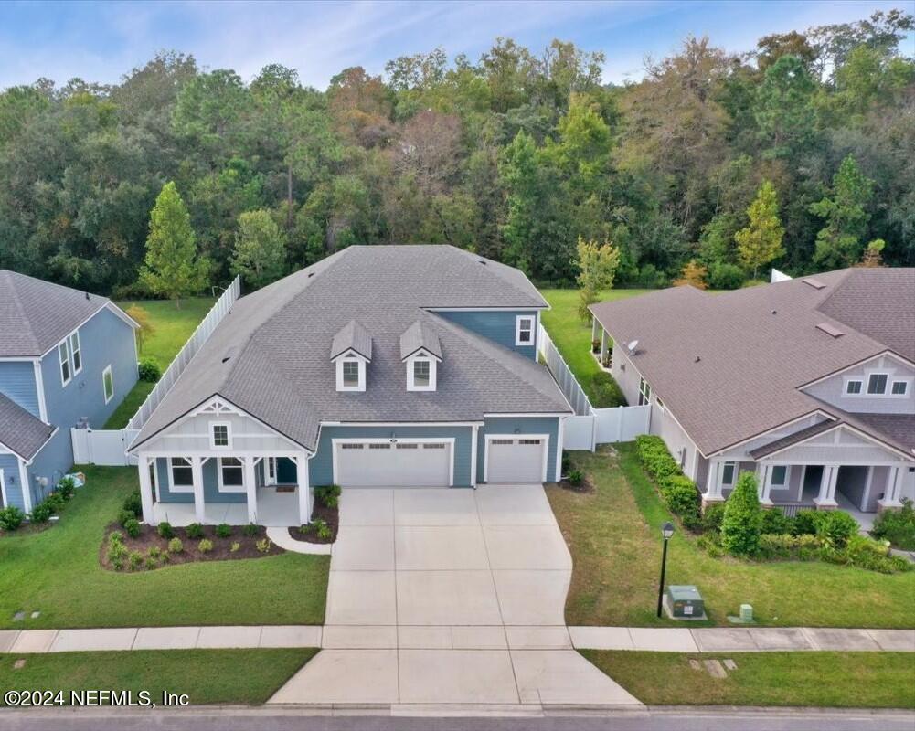 an aerial view of a house next to a yard