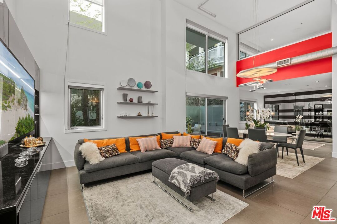 a living room with furniture and a floor to ceiling window