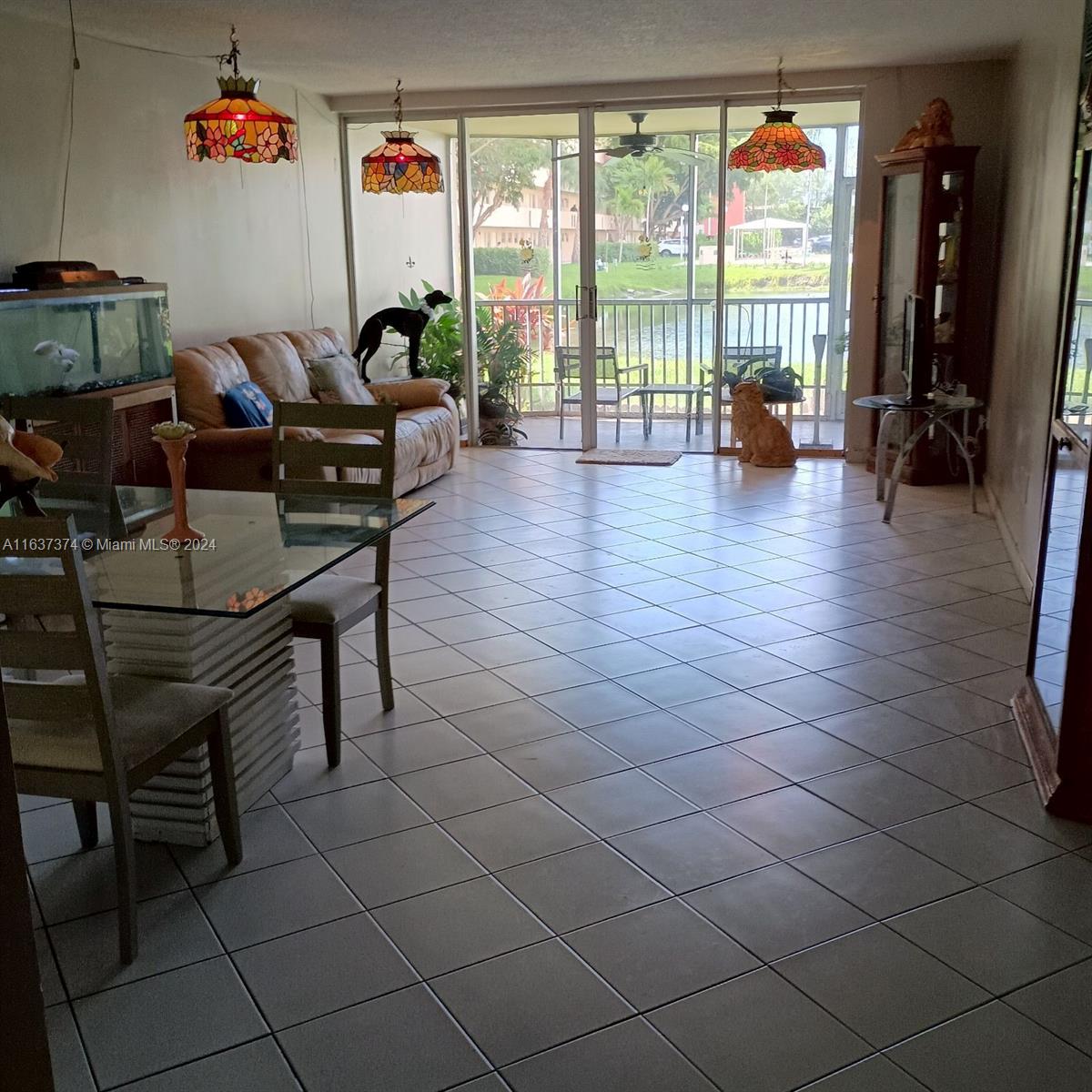 a living room with furniture and a floor to ceiling window