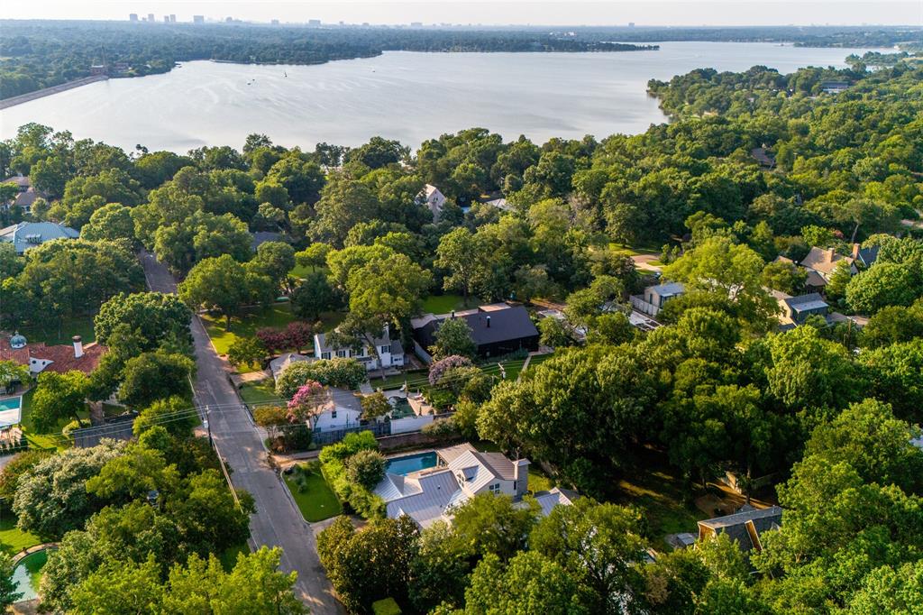 an aerial view of a houses with outdoor space and lake view