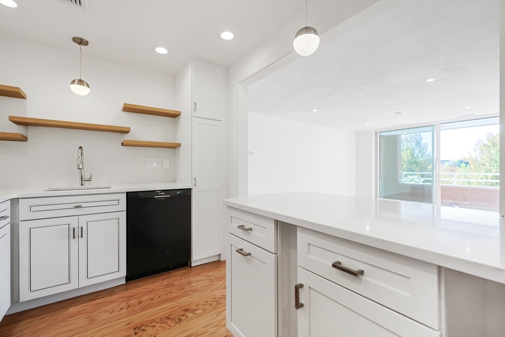 a kitchen with white cabinets and appliances