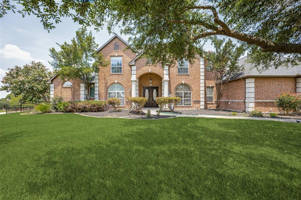 a front view of house with yard and green space