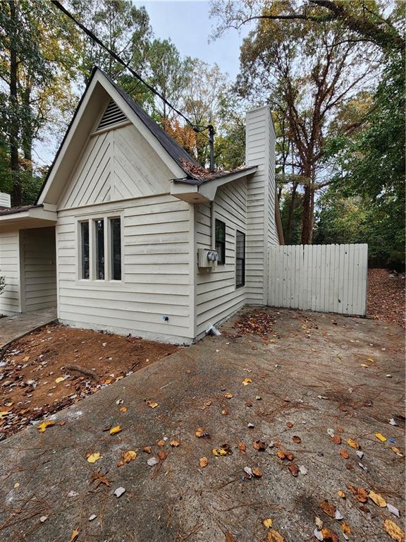 a view of a small house with a yard