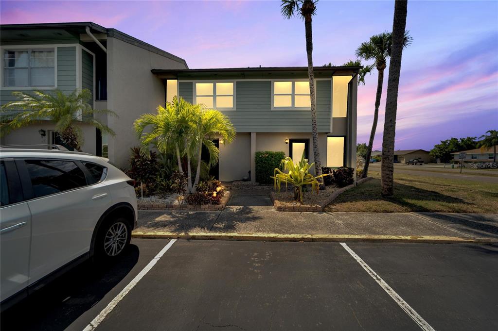 a view of a house with a cars park