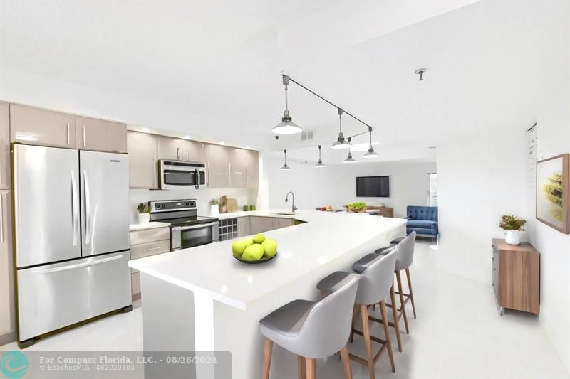 a kitchen with stainless steel appliances a dining table and chairs