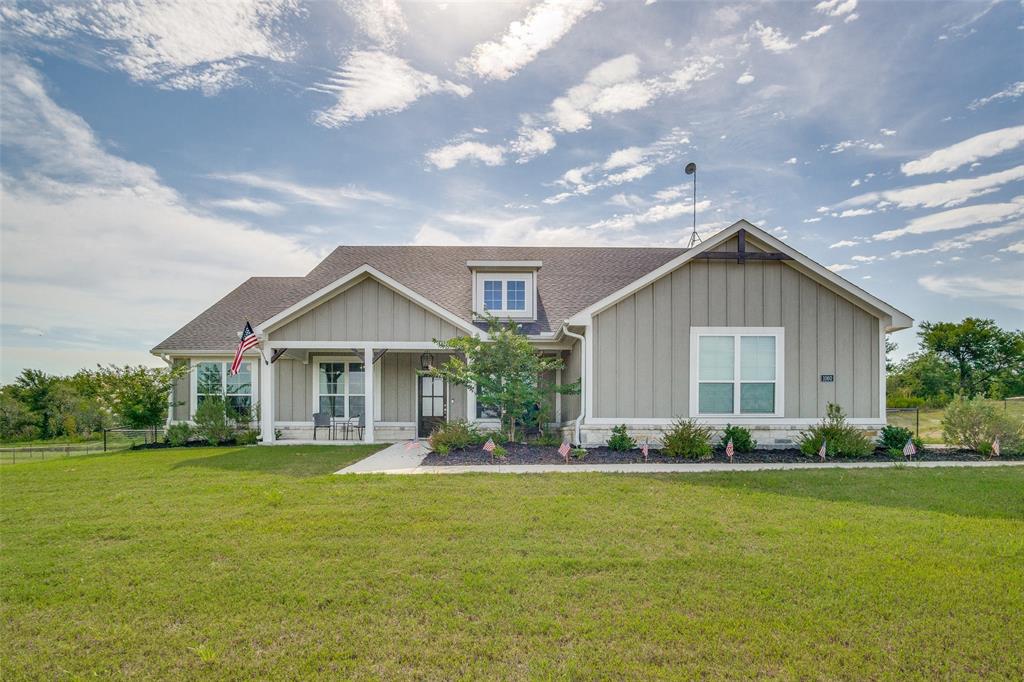 a front view of house with yard and green space