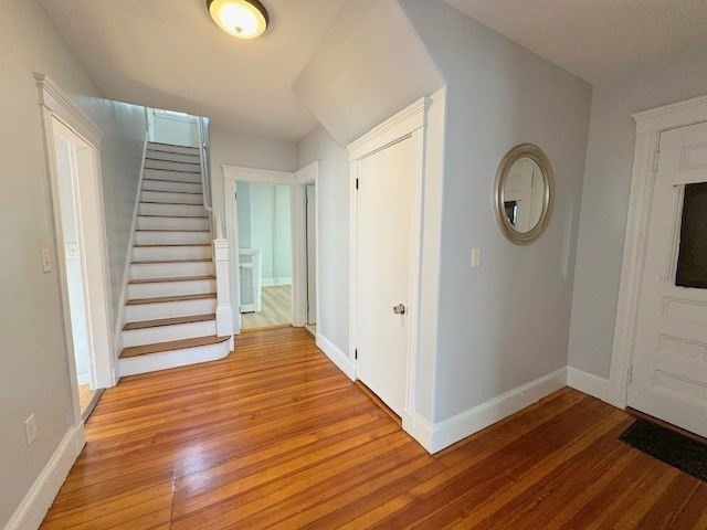 a view of a room with wooden floor and white walls