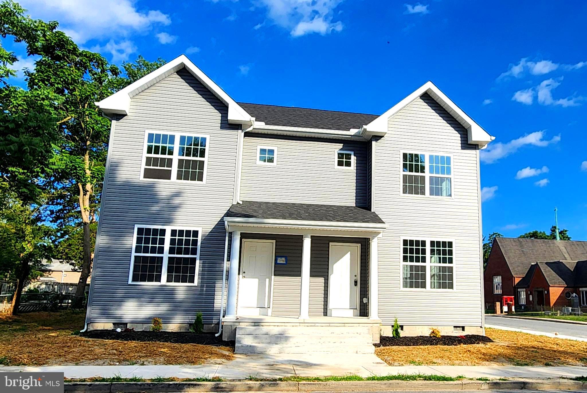 a front view of a house with a yard