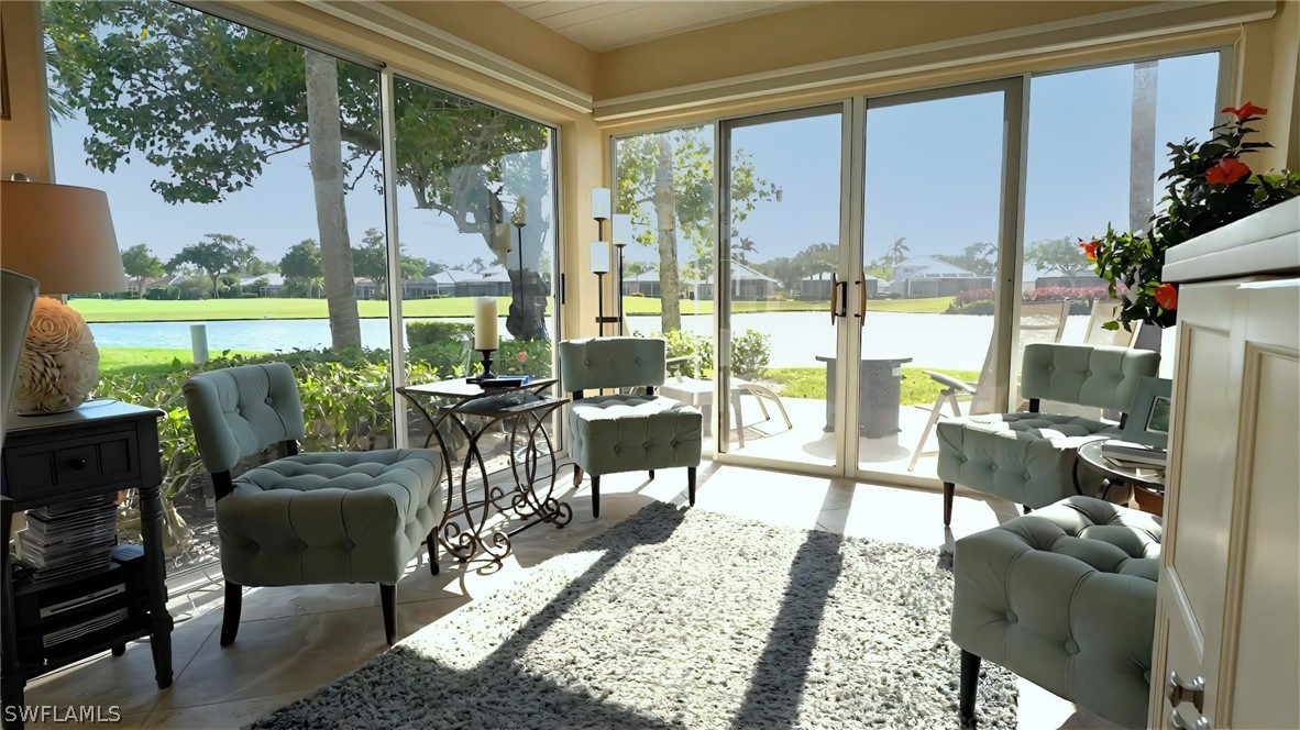 a living room with furniture and a floor to ceiling window