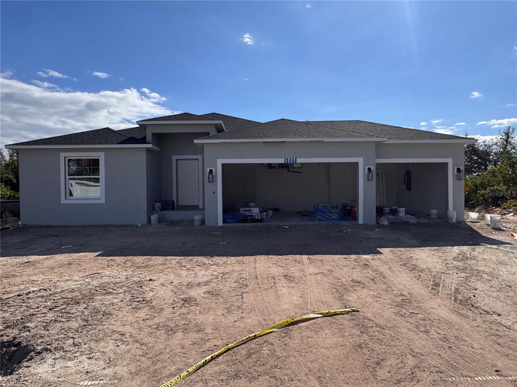 a front view of a house with a yard and a garage