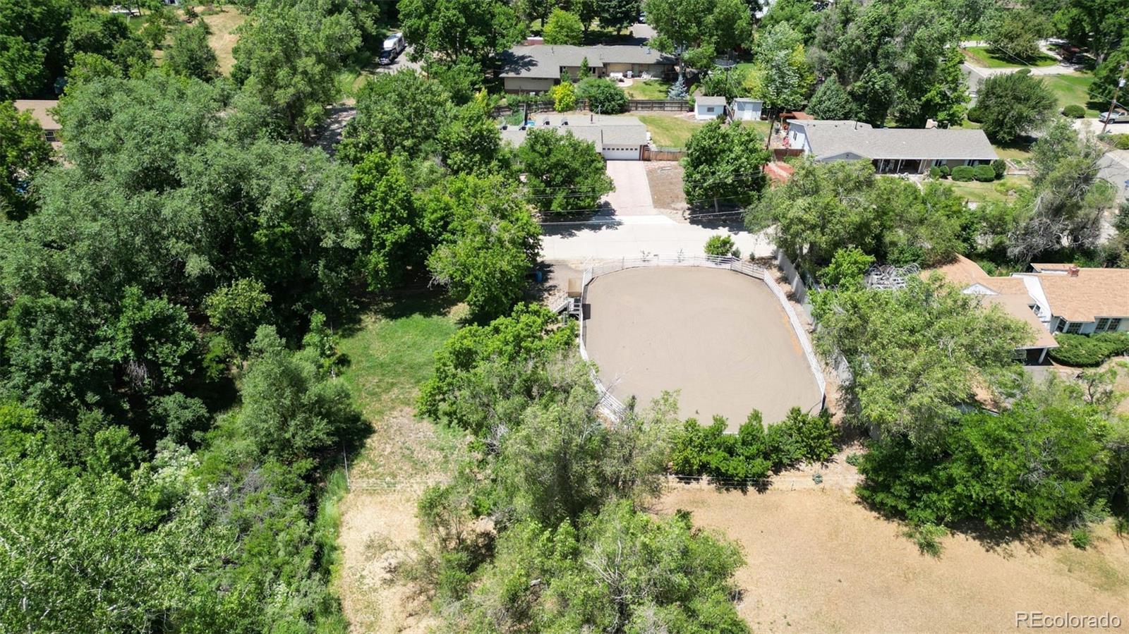 an aerial view of a house with yard and outdoor seating