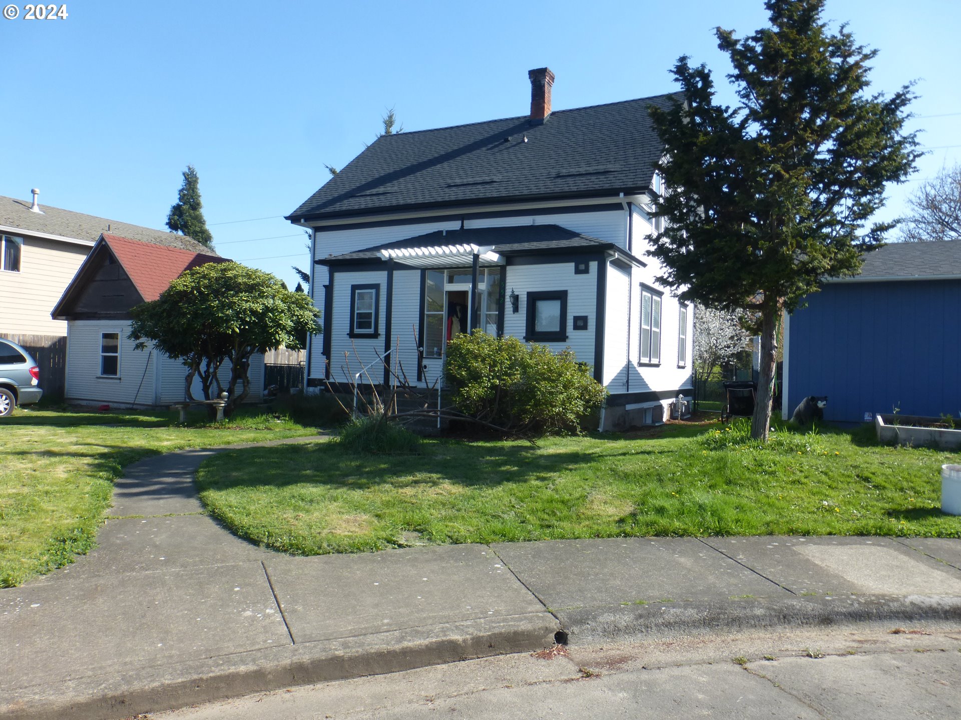 a front view of house with a garden