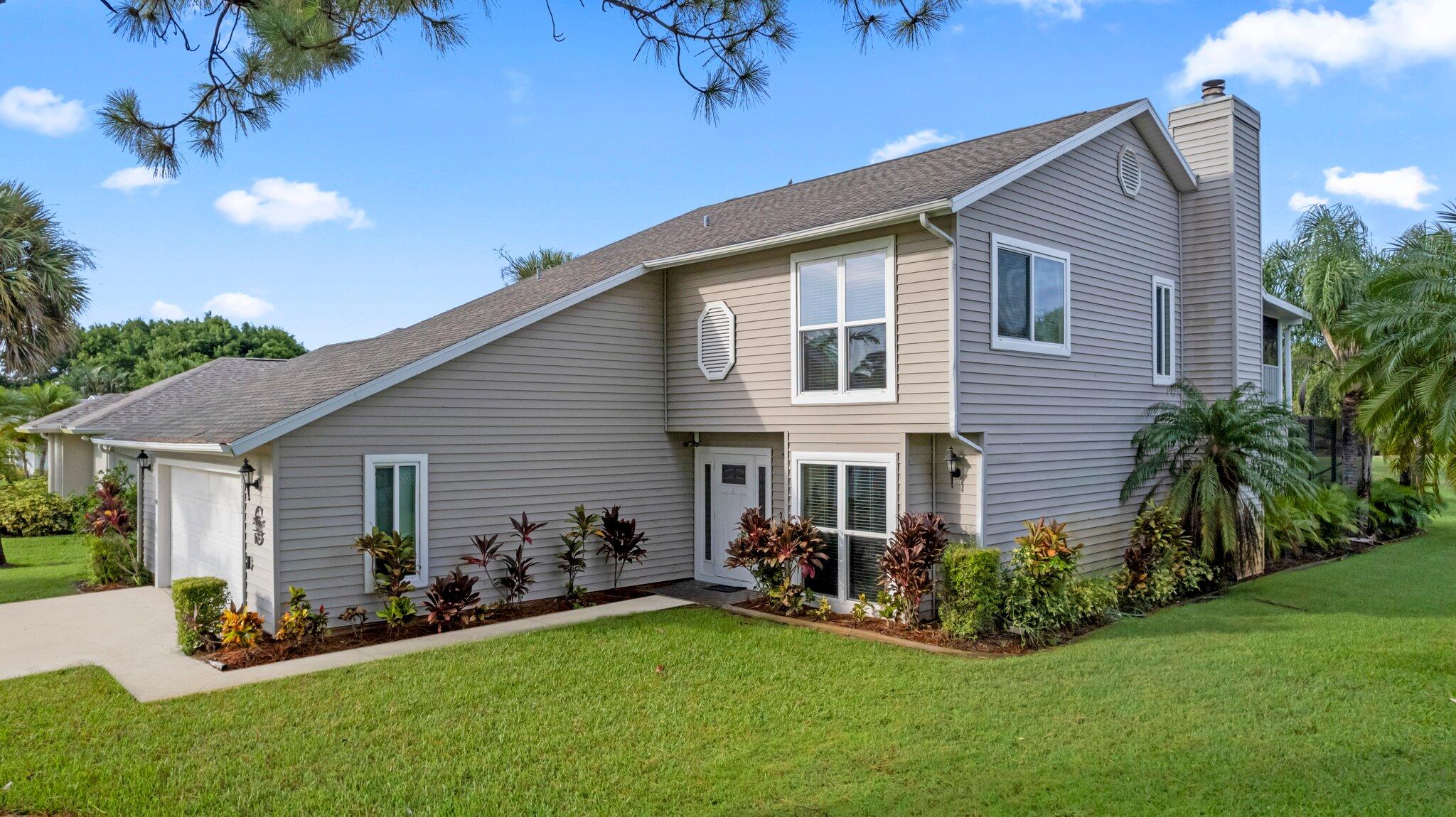 a front view of house with yard and green space