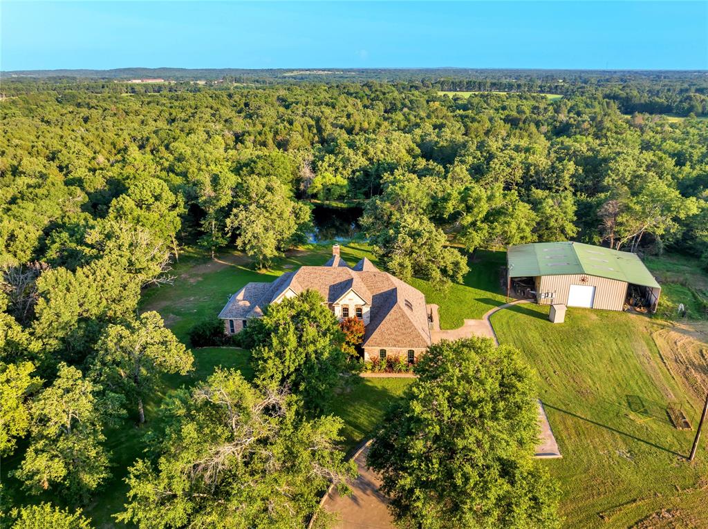 an aerial view of a house with a yard