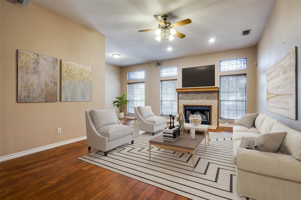 a living room with furniture a fireplace and a flat screen tv