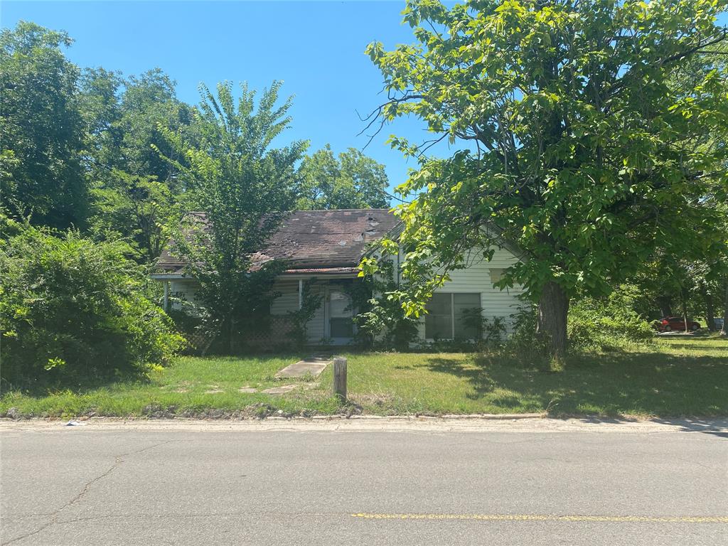 a front view of a house with a yard and a garage