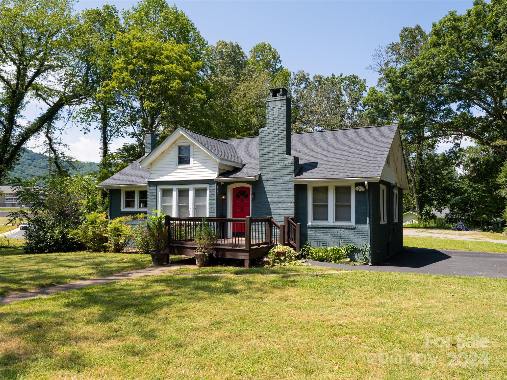 a front view of a house with swimming pool and yard