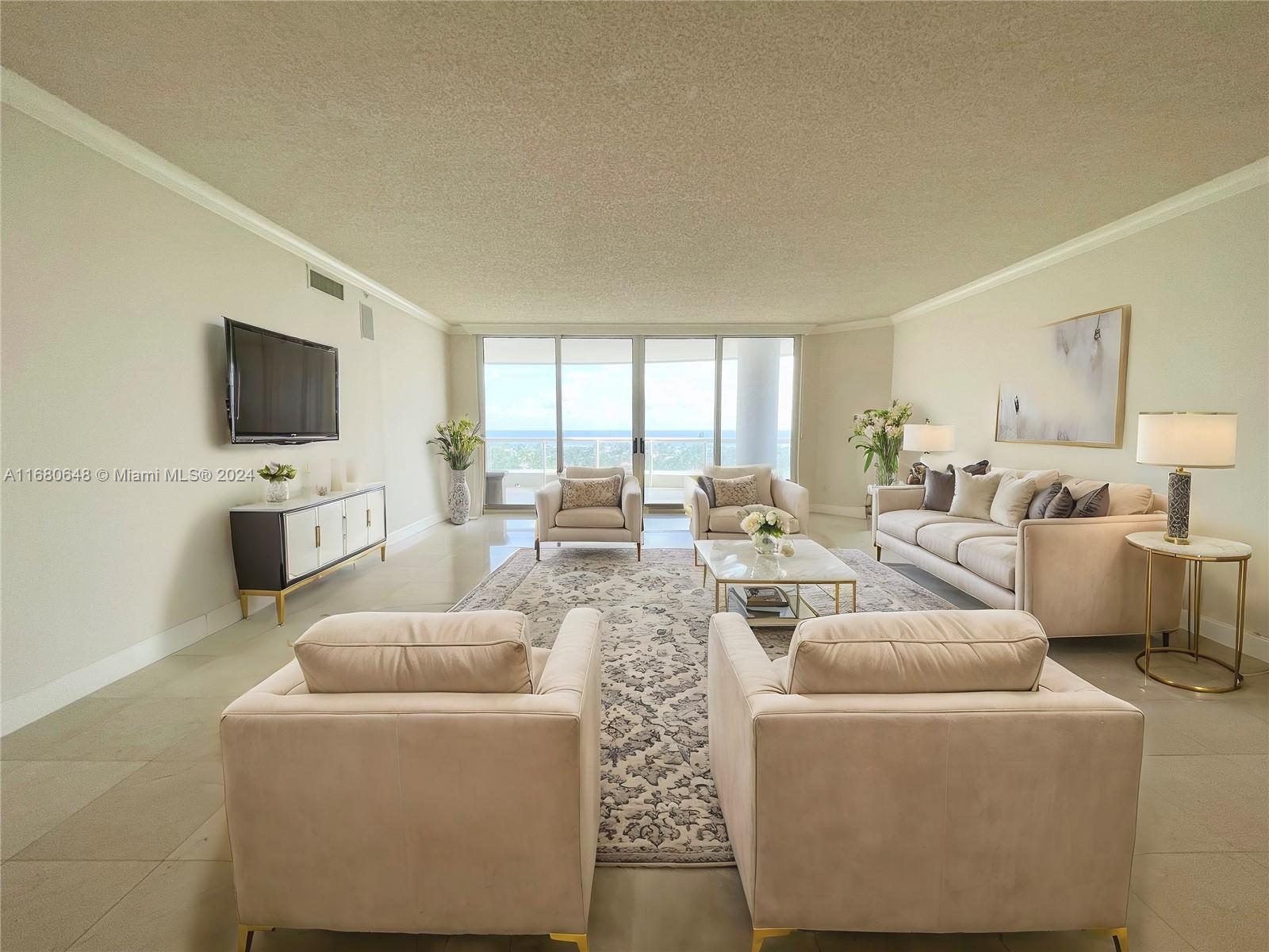 a living room with furniture a flat screen tv and a large window