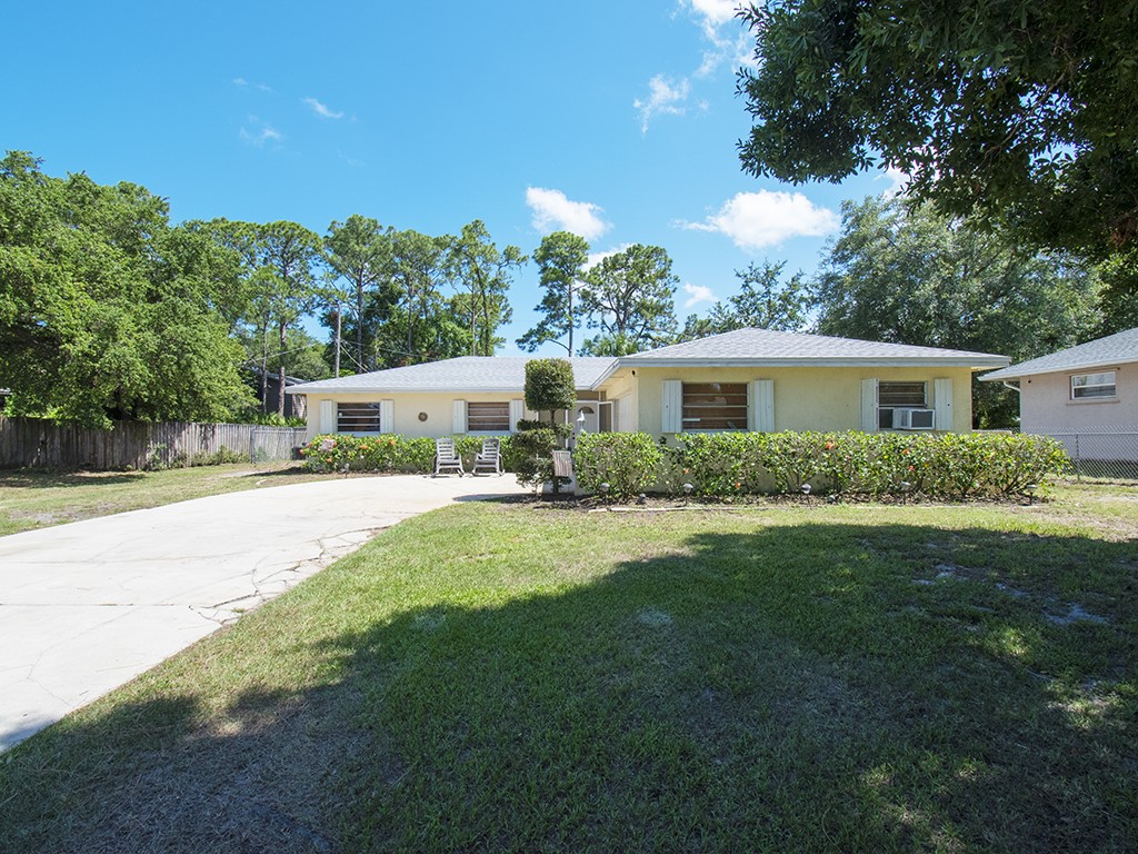 a view of house with outdoor space and yard