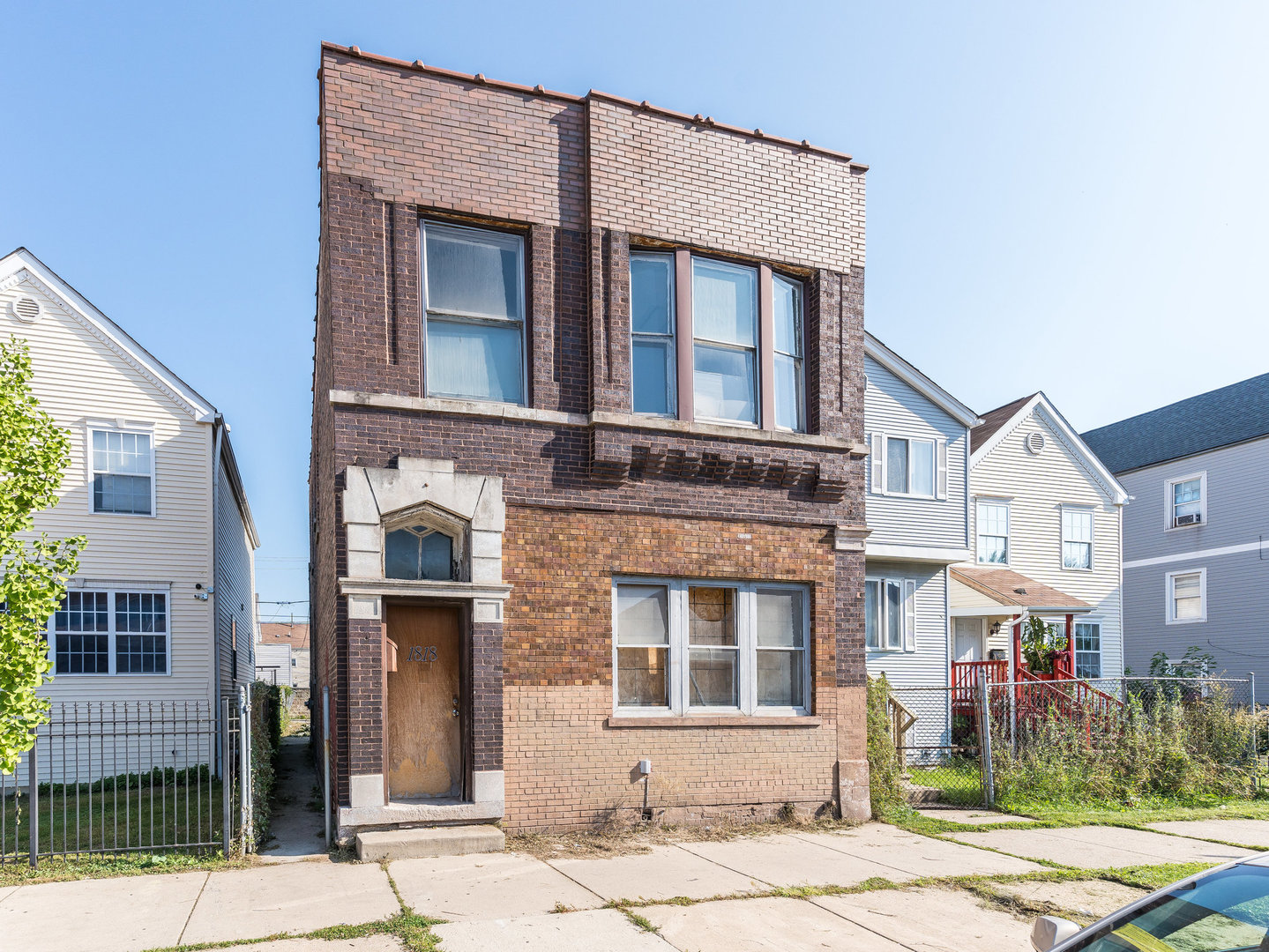 a front view of a residential apartment building with a yard