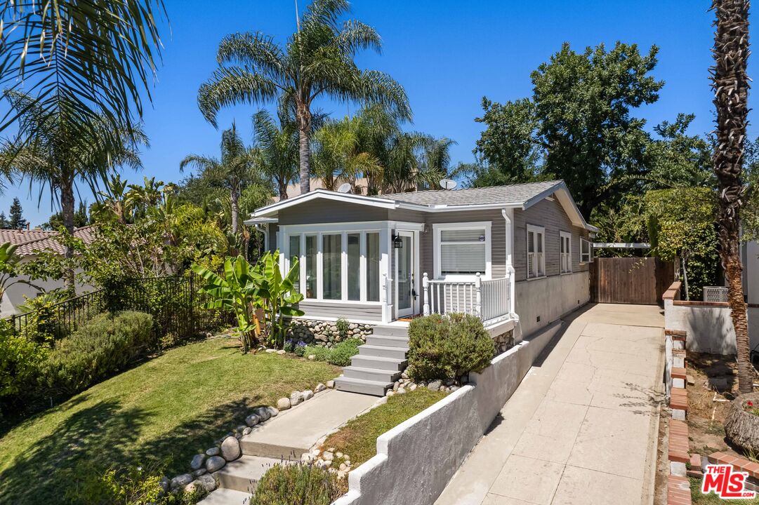 a front view of a house with a garden