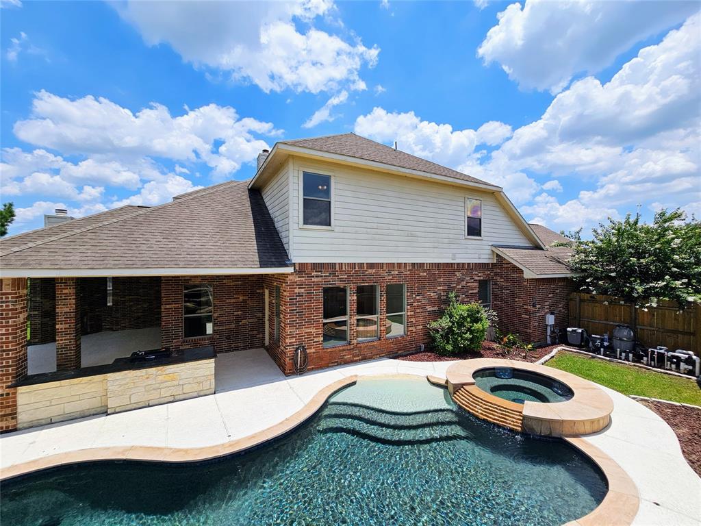 a view of a house with backyard and sitting area