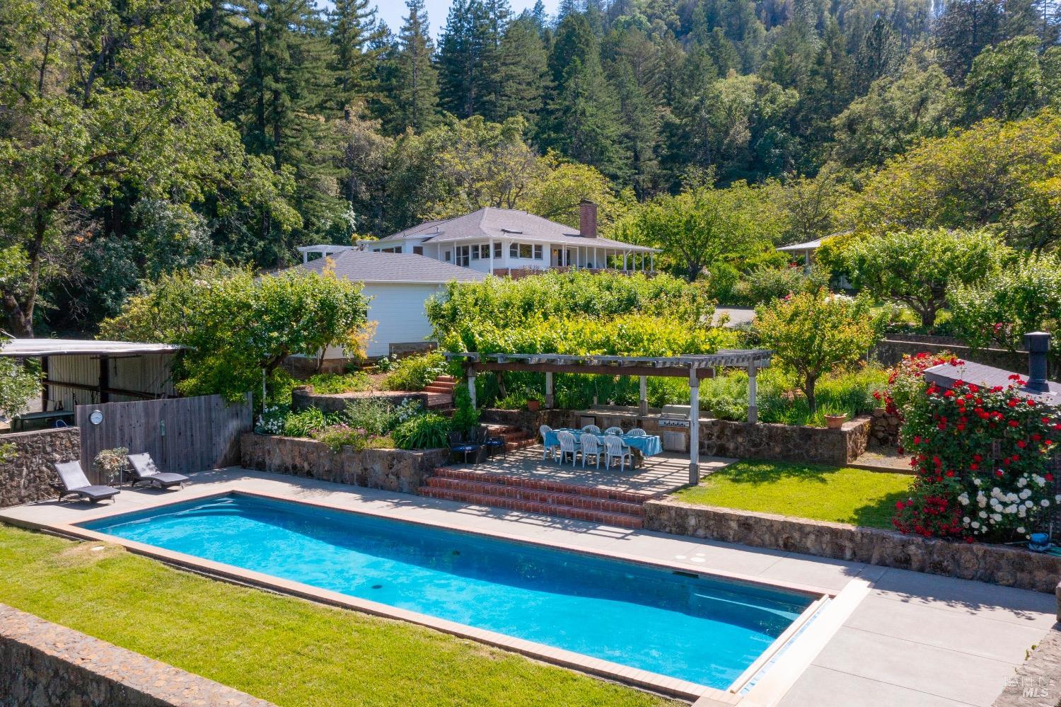 a view of a swimming pool with a patio and a yard