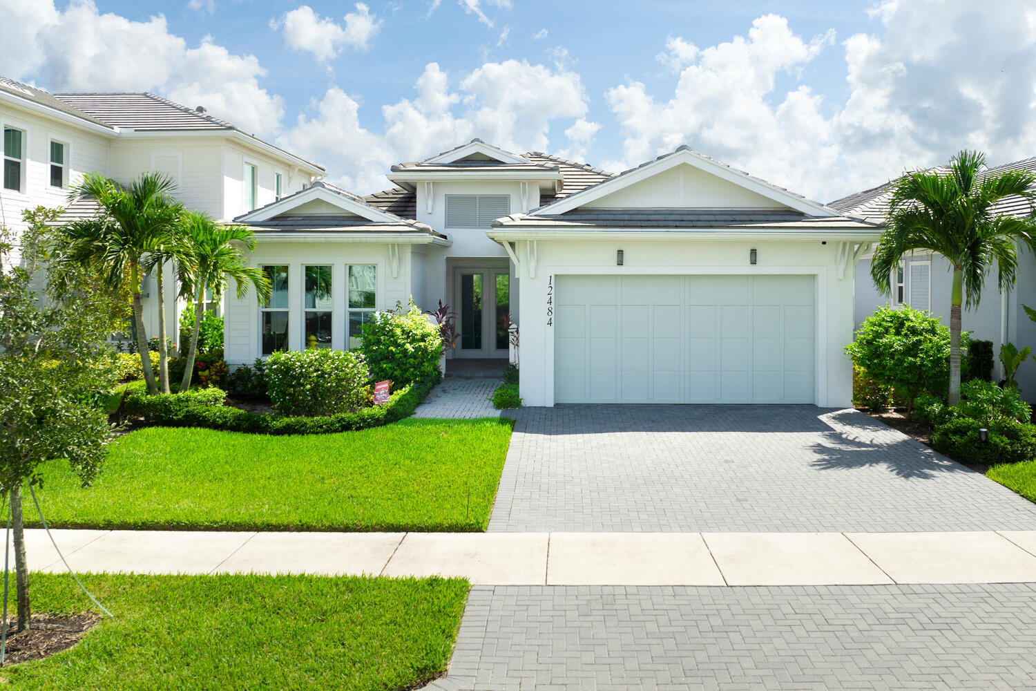 a front view of a house with a garden