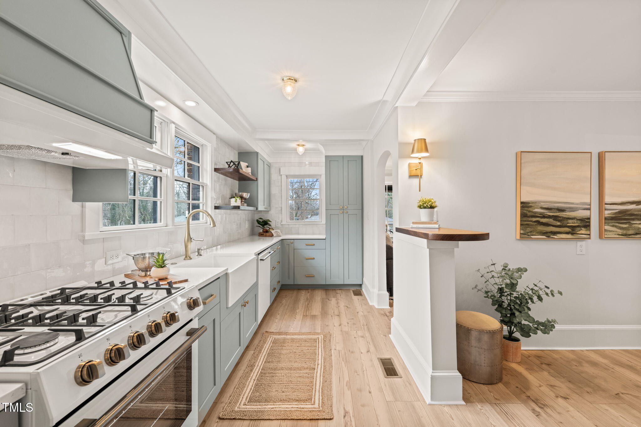 a kitchen with stove and white cabinets