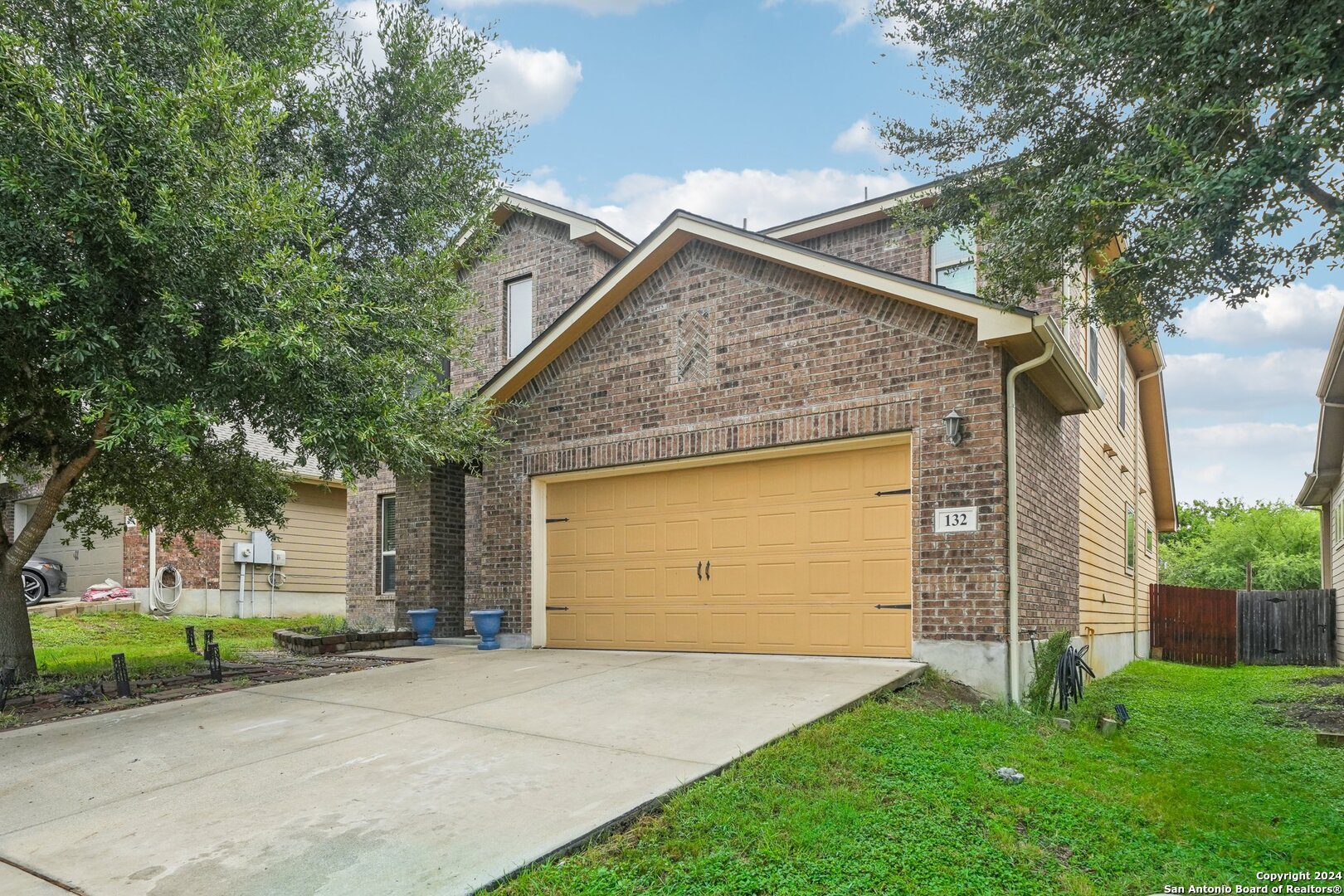 a view of a house with a yard and garage