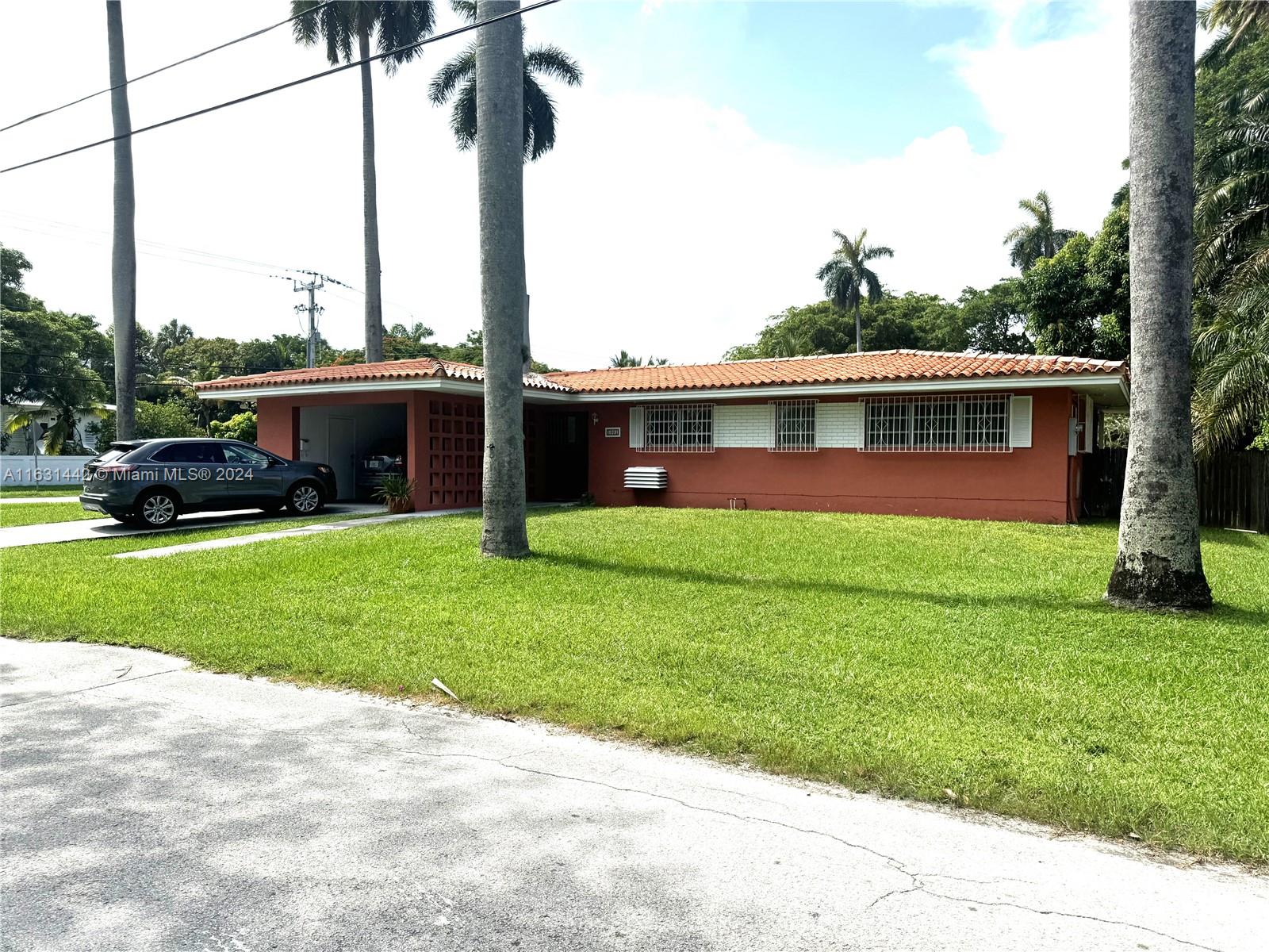 a front view of house with yard and green space