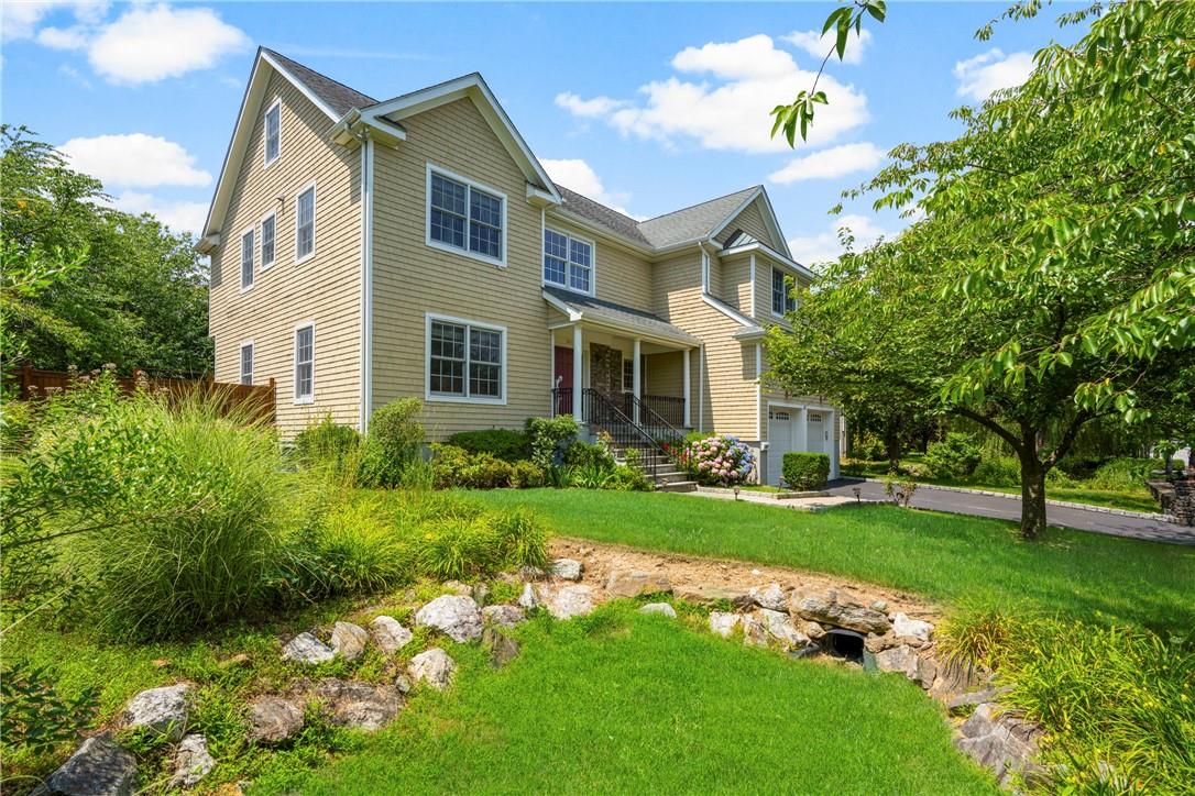 a front view of house with yard and green space