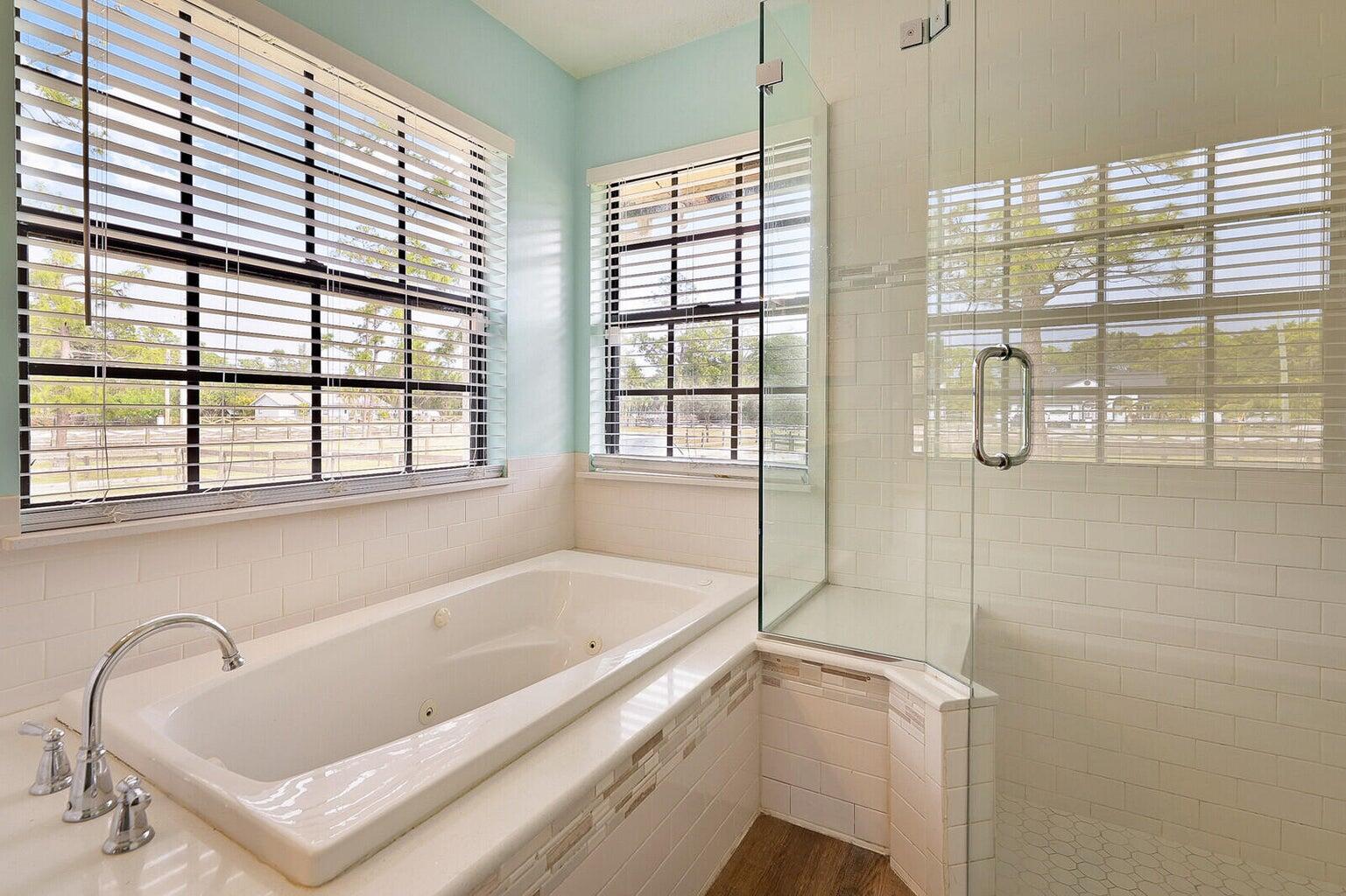 a bathroom with a tub and a window