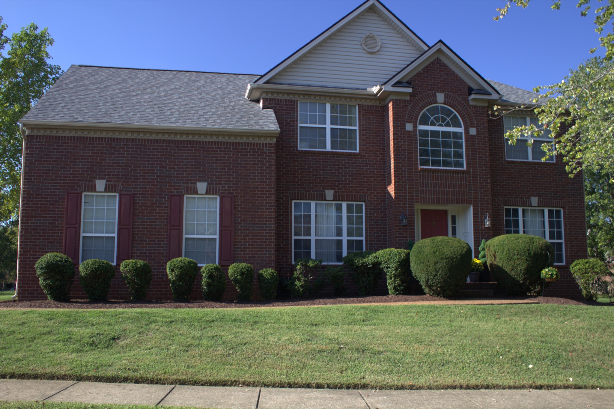 a front view of a house with a yard