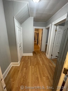 a view of hallway with wooden floor