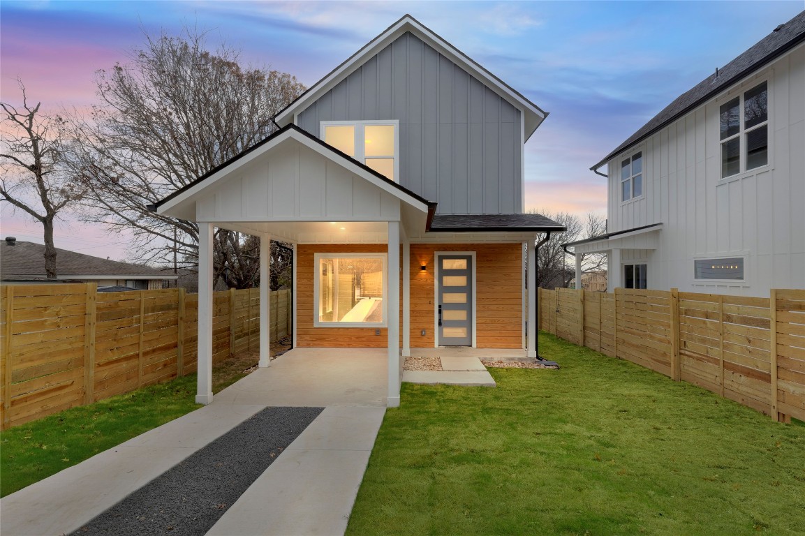 a view of a house with a yard and porch