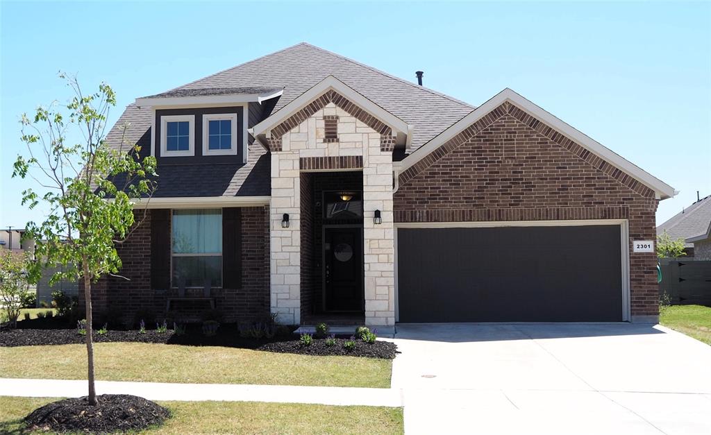 a front view of a house with garage