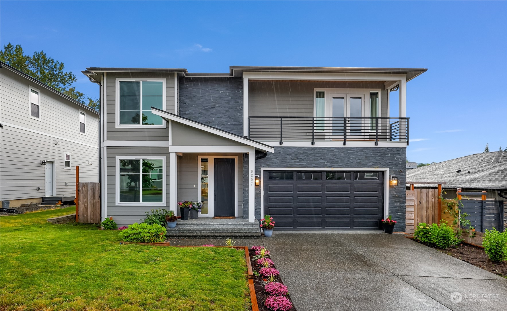 a front view of a house with a yard and garage