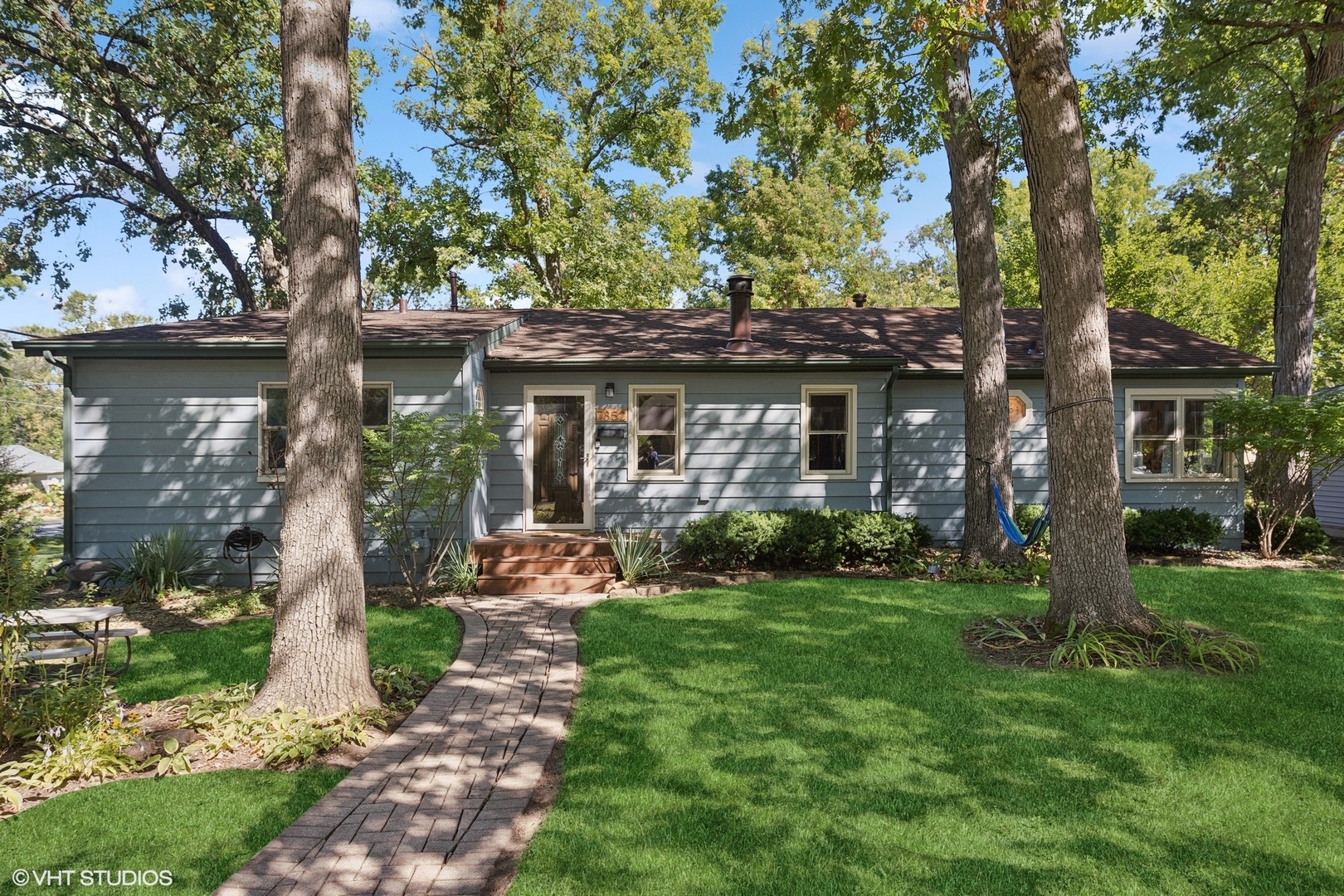 a front view of a house with garden