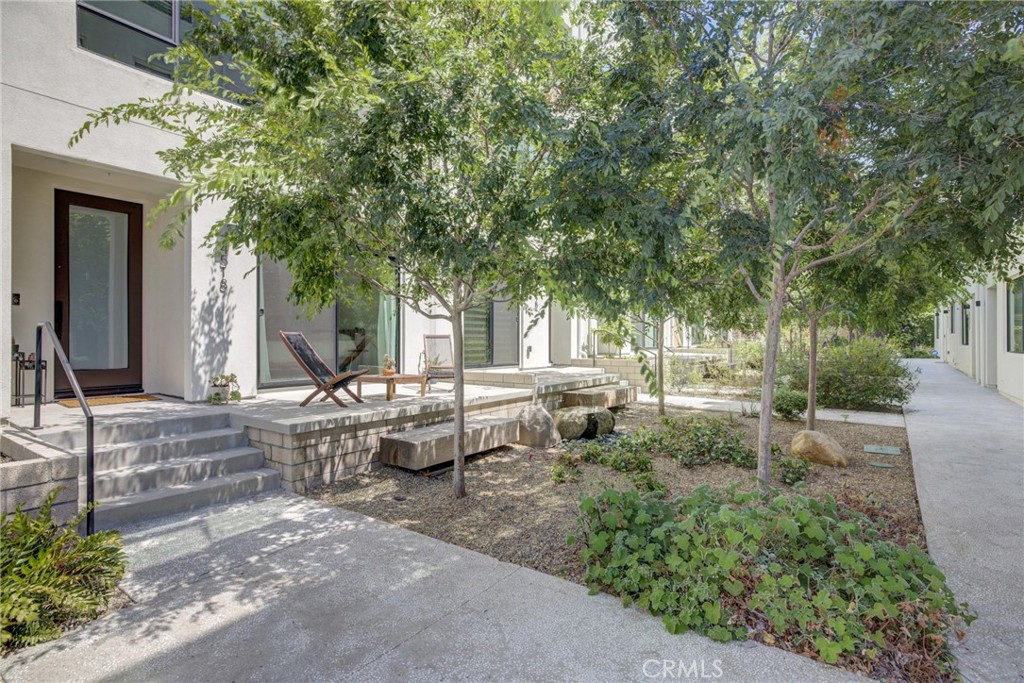 a view of backyard of house with outdoor seating and green space