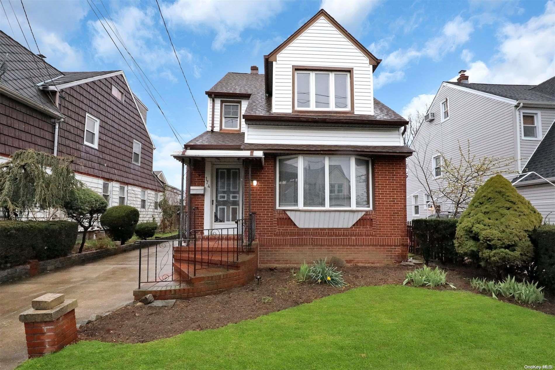 a front view of a house with a yard and outdoor seating