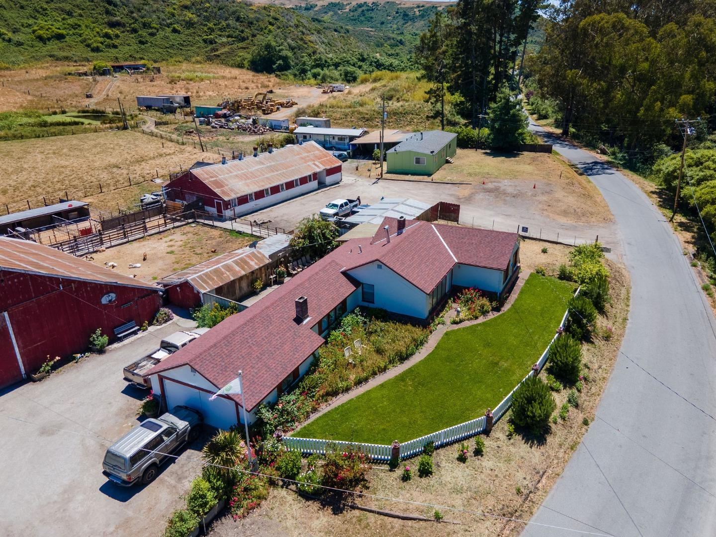 an aerial view of a house with outdoor space and lake view