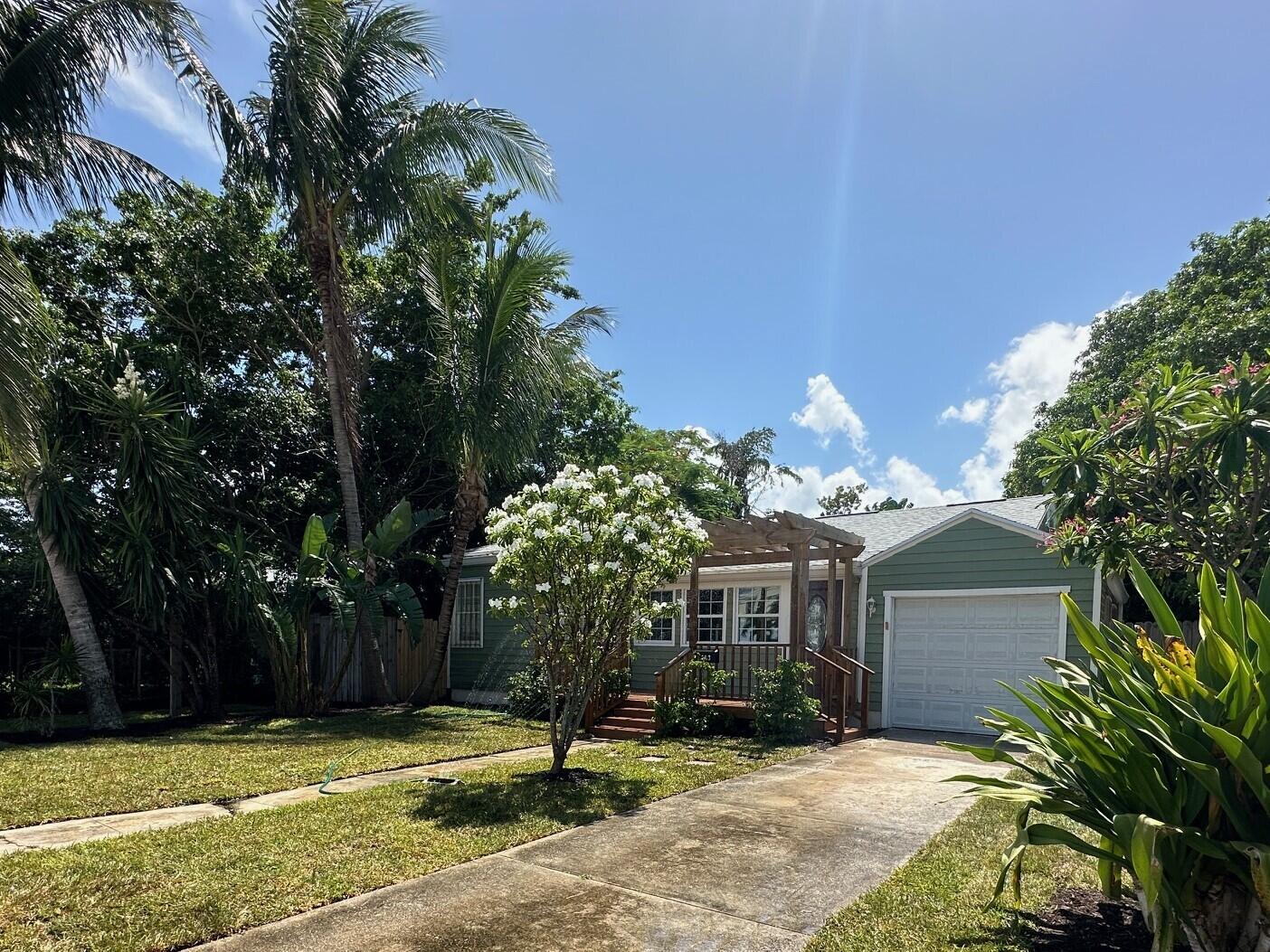 a view of a house with a yard and tree s