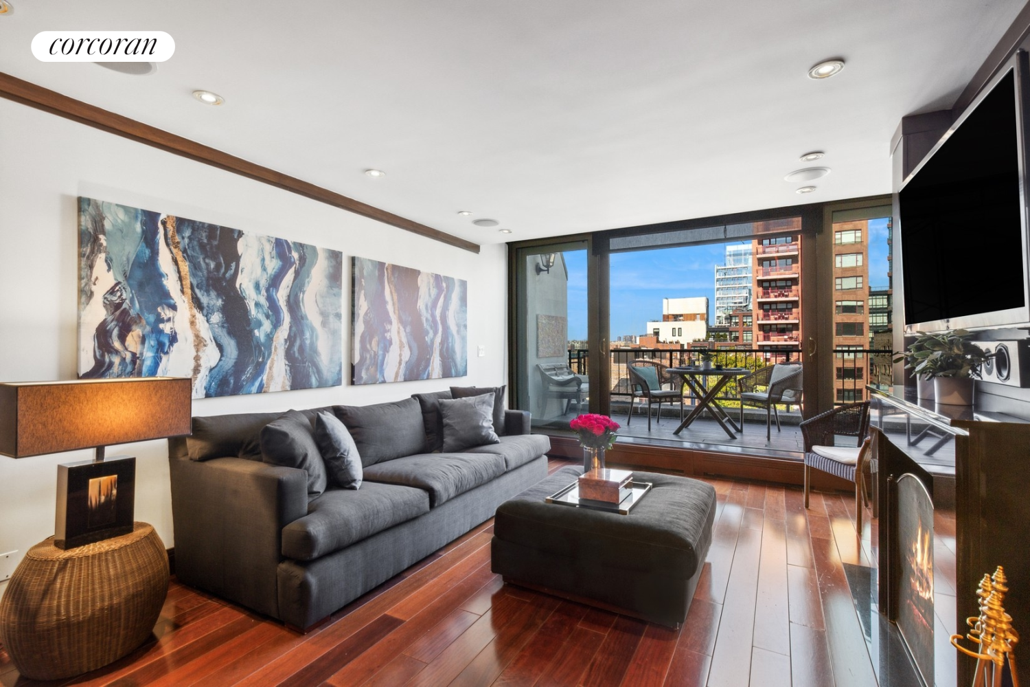 a living room with furniture flat screen tv and a large window