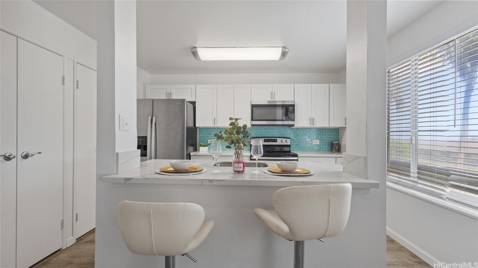 a kitchen with a refrigerator a stove and a sink